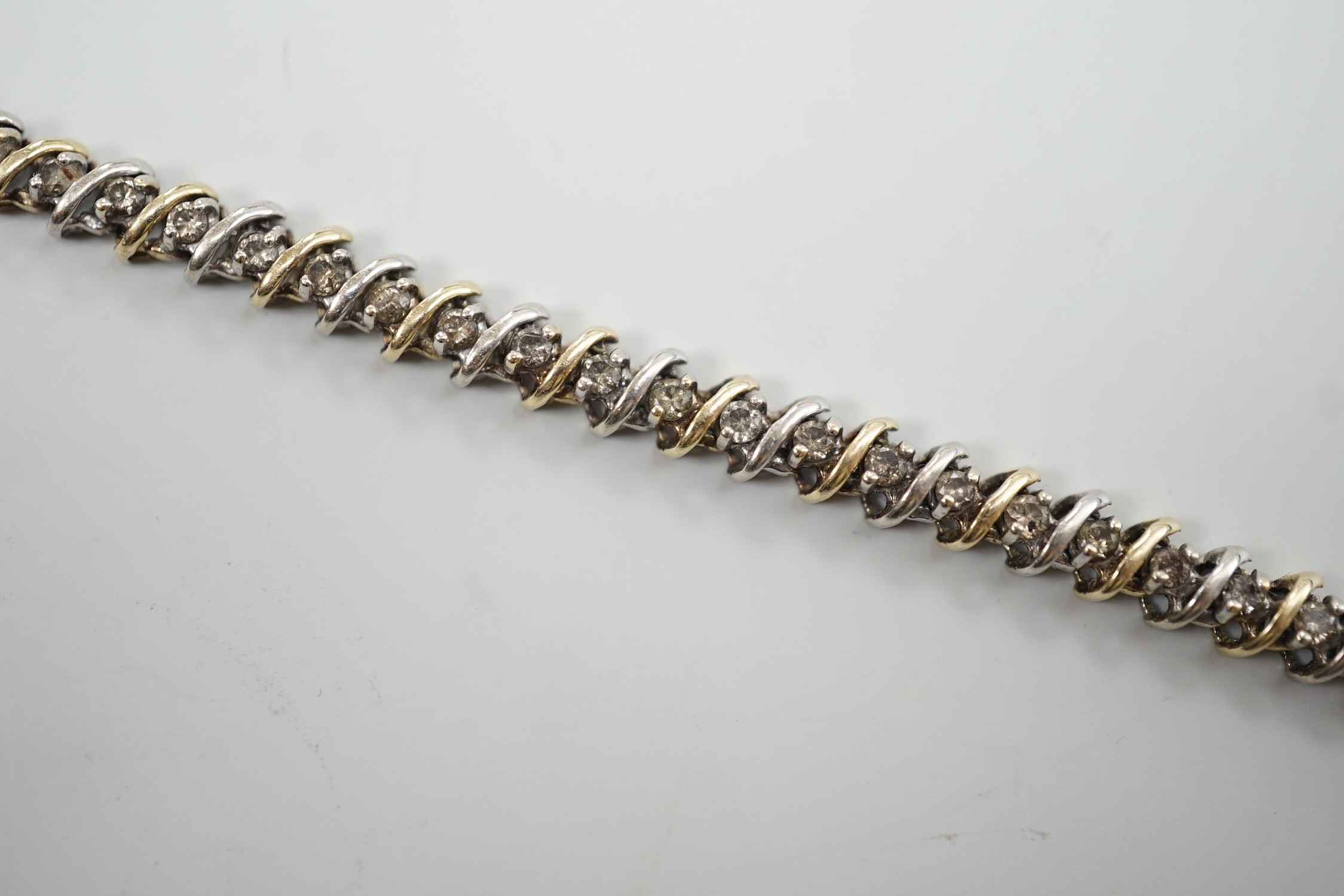 A modern two colour 14k and diamond chip set bracelet, 18.5cm, gross weight 12.7 grams.